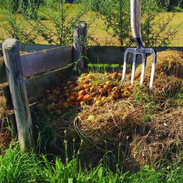 garden fork turns compost piles